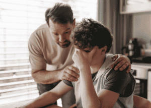 Teenage boy sitting at the table overstimulated, Neurodivergent vs Neurotypical