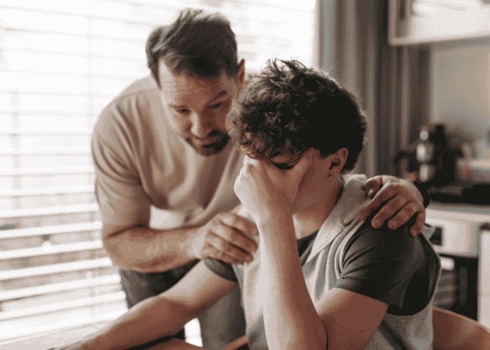 Teenage boy sitting at the table overstimulated, Neurodivergent vs Neurotypical
