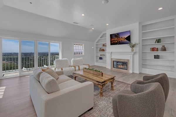 Bright living room with sofa and comfortable chairs around a coffee table