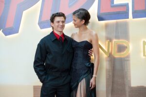 Tom Holland smiling with arm around Zendaya at Spider-Man Brand New Day movie premier